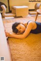 A woman laying on the floor in a living room.