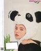 A woman wearing a panda hat in a magazine.